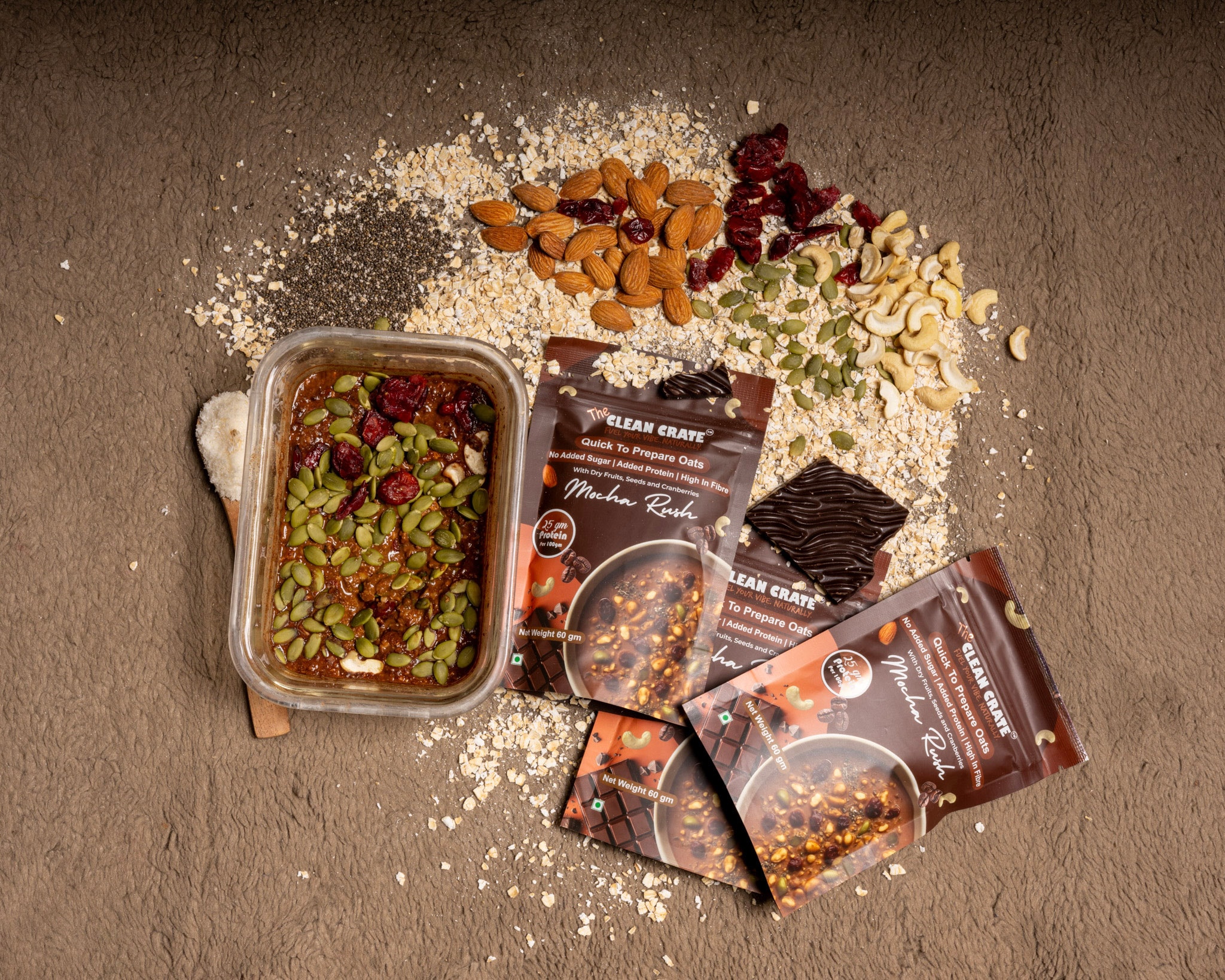 Mocha Rush protein oats by The Clean Crate, surrounded by oats, almonds, cranberries, pumpkin seeds and dark chocolate